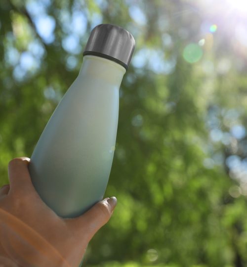 Man,Holding,Thermo,Bottle,In,Park,On,Sunny,Day,,Closeup.